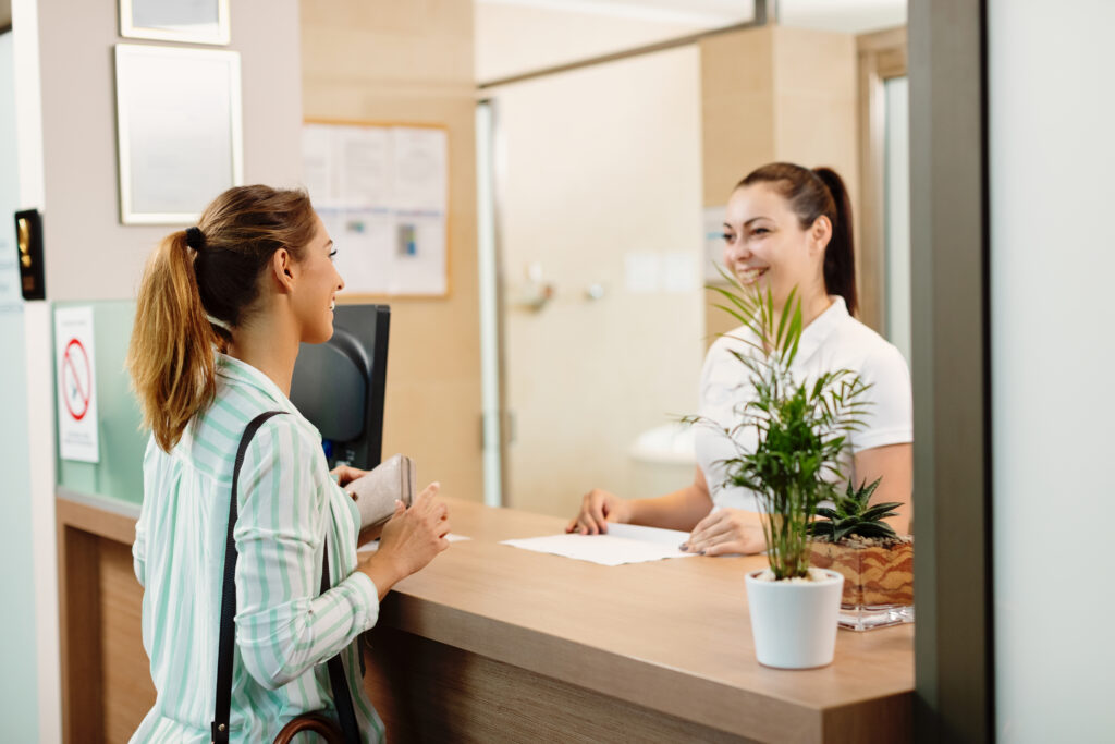 woman talking to a receptionist